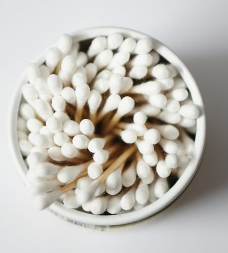 Top view of cotton buds stacked in a container, emphasizing hygiene and healthcare.